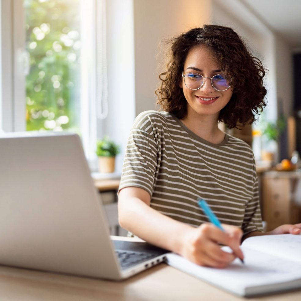 Young woman, a university student, studying online.